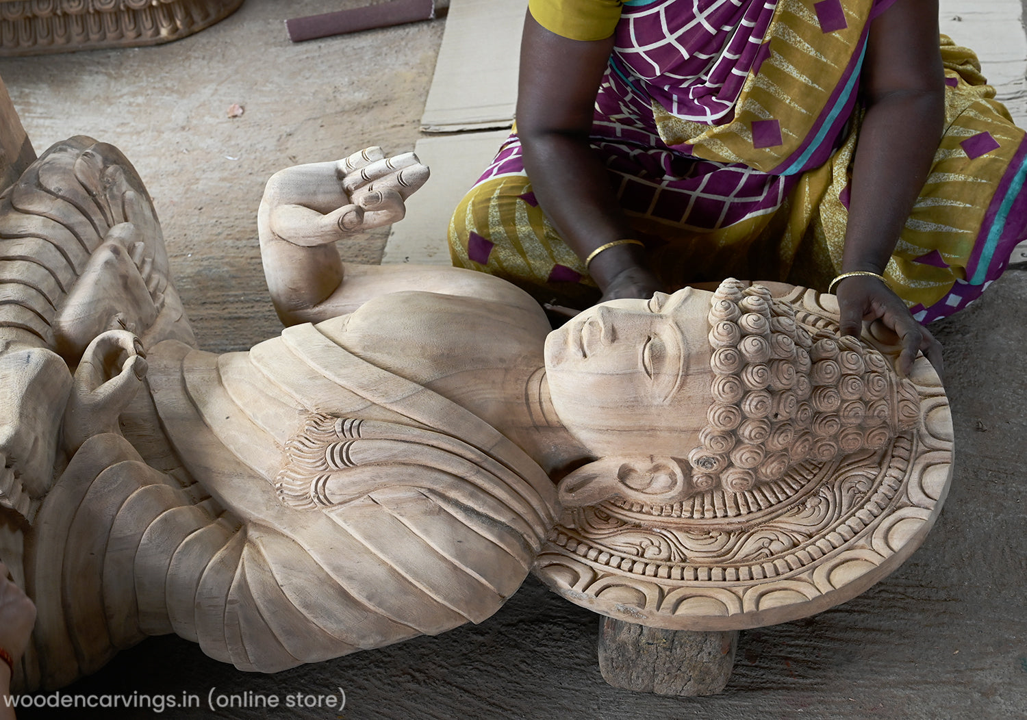 Wooden sanding process on Buddha statue